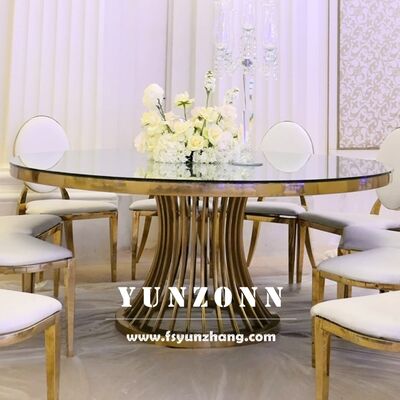 Prezzo buono Tavolo da pranzo rotondo di lusso con base in acciaio inossidabile dorato e copertura in vetro per matrimoni e banchetti in linea